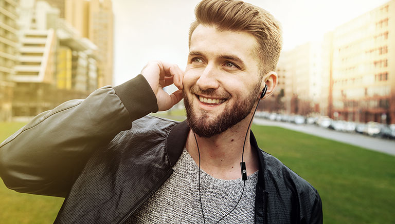 Model wears MOTO Earbuds 105 in ear headphones in black